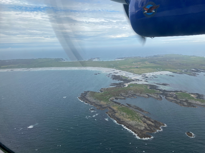 Looking out of a plane window on land and water