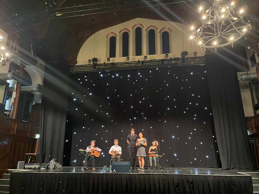 Ceilidh band on stage at Teviot Debating Hall with atmospheric lighting