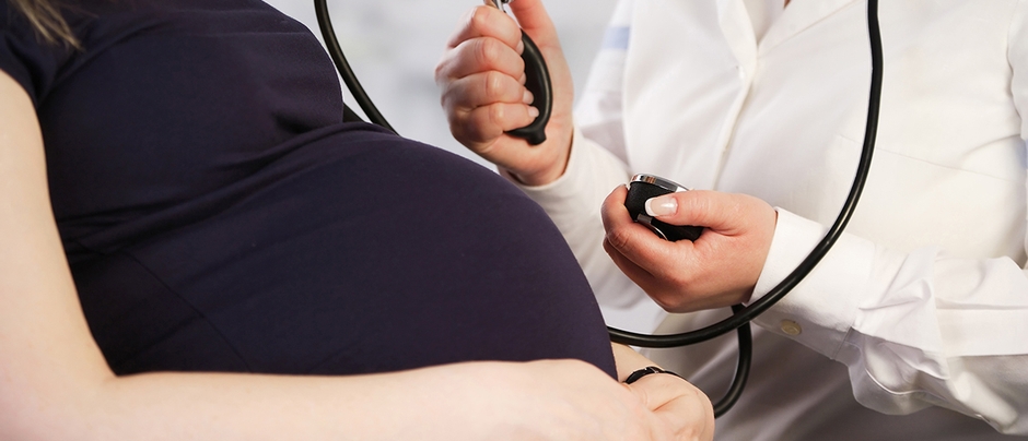 A pregnant woman having her blood pressure measured