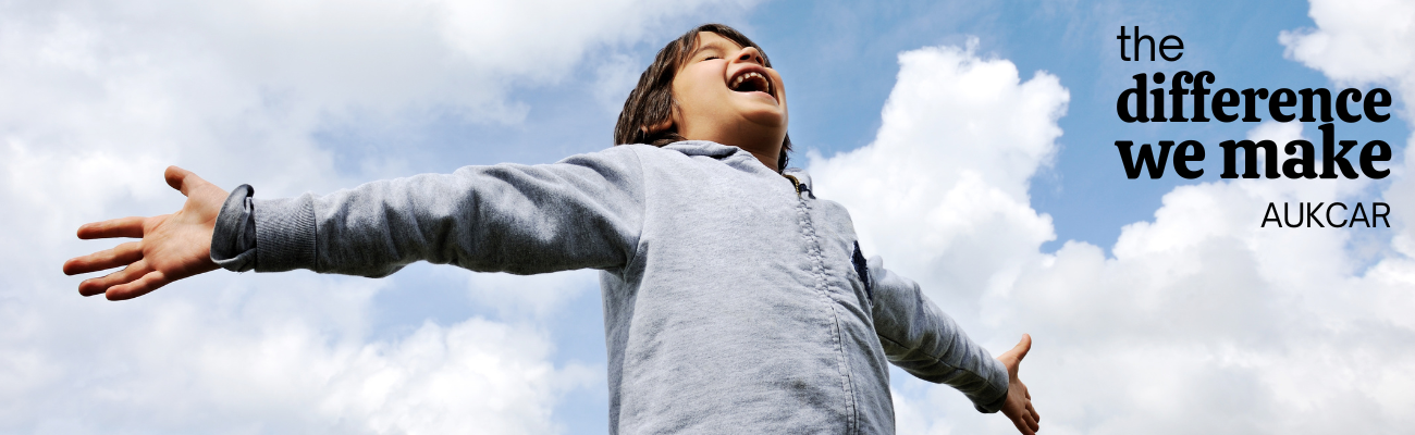 Young person breathing happily with arms open in the fresh air