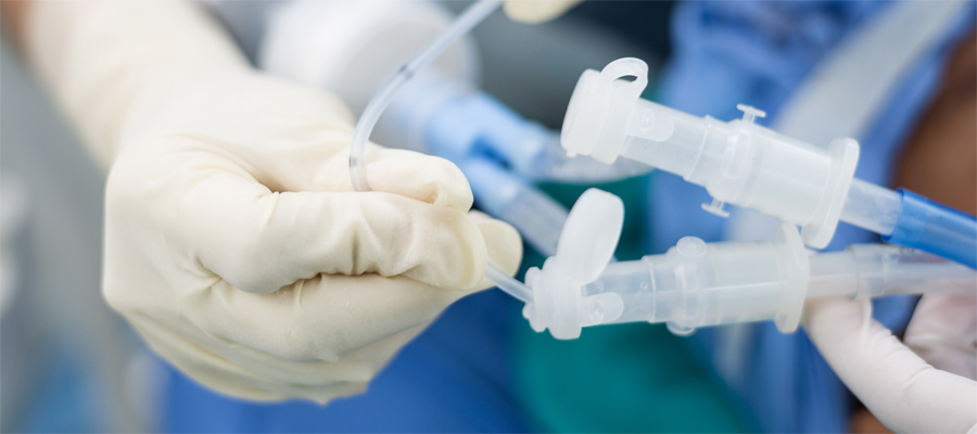 close up of medics hand adjusting ventilation tubing 